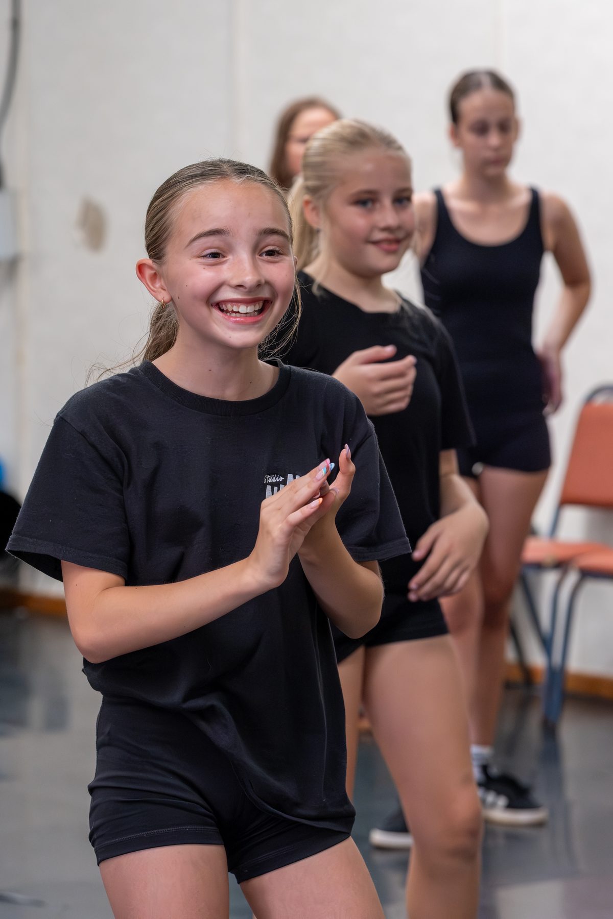 A young Studio 19 dancer smiling in class